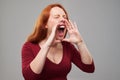 Portrait of disparate redhead woman loudly screaming Royalty Free Stock Photo