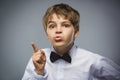 Portrait of displeased angry boy with threatens finger isolated on gray background. Negative human emotion, facial Royalty Free Stock Photo