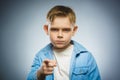 Portrait of displeased angry boy with threatens finger isolated on gray Royalty Free Stock Photo