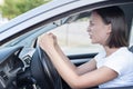 Angry woman driving a car gesturing with rudeness