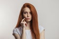 Portrait of displeased attractive redhaired woman isolated over white background