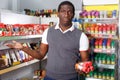 Portrait of dissatisfied African man choosing spice in supermarket