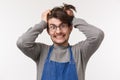 Portrait of distressed and tensed young male barista going insane with lots orders, pulling hair out of head crazy look Royalty Free Stock Photo