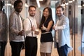 Portrait diverse employees standing in office hallway, showing thumbs up Royalty Free Stock Photo