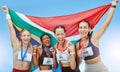 Portrait diverse group of female olympic athletes holding winners medals and African flag. Happy and proud champions of Royalty Free Stock Photo