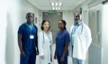 Portrait of diverse group of four doctors and healthcare workers in hospital corridor Royalty Free Stock Photo