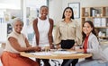 Portrait of diverse group of young ethnic business women having a brainstorm meeting in office. Ambitious confident Royalty Free Stock Photo