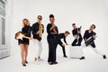 Portrait of diverse group of young people musical band playing with instruments - isolated on white background.