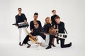 Portrait of diverse group of young people musical band playing with instruments - isolated on white background. Royalty Free Stock Photo