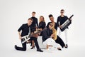 Portrait of diverse group of young people musical band playing with instruments -  on white background. Royalty Free Stock Photo