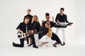 Portrait of diverse group of young people musical band playing with instruments -  on white background. Royalty Free Stock Photo