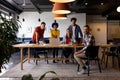 Portrait of diverse male and female colleagues using laptop and tablet in casual office meeting Royalty Free Stock Photo