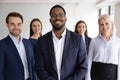 Portrait of diverse staff lead by African leader photoshooting indoor Royalty Free Stock Photo