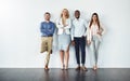 Portrait, diversity and collaboration with business people in studio together against a gray wall for mockup. Teamwork