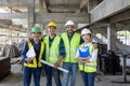 Portrait of the diversity team of engineer, architect, worker and safety manager smiling together at the construction site wearing Royalty Free Stock Photo