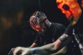 Portrait of Djs with skull masks playing mixing music at party festival. Royalty Free Stock Photo