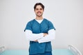 Portrait, doctor and arms crossed for smile in space for health, treatment or wellness. Happy man, nurse and scrubs for Royalty Free Stock Photo