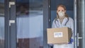 Portrait of a doctor with a box of protective medical masks.