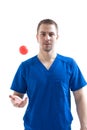 Portrait of doctor. The doctor holds in his hands and demonstrates a special medical ball for massage. Isolate on a white