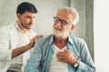 Portrait of doctor is examining physical symptom of senior patient in examination room, Healthcare and occupational concept Royalty Free Stock Photo