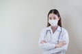 portrait doctor female wearing mask and uniform with stethoscope arms crossed looking at camera. woman nurse standing at hospital Royalty Free Stock Photo