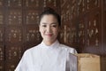 Portrait of Doctor In Front of Traditional Chinese Medicine Cabinet Royalty Free Stock Photo