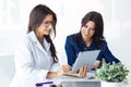 Doctor and her patient choosing mammary prosthesis in the office