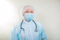 Portrait of a doctor man in a medical mask. There is a stethoscope on the doctor`s neck. During a pandemic, remedies are essentia