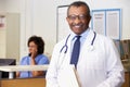 Portrait Of Doctor At Nurses Station Royalty Free Stock Photo