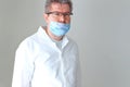 Portrait of a doctor in a respiratory mask on a white background