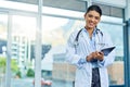 Portrait, doctor and smile of woman with tablet in hospital for research, telehealth or healthcare. Face, happiness and Royalty Free Stock Photo