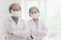 Portrait of doctor standing with arms cross,team of surgeons and anesthetists and emergency room physicians, with a hospital Royalty Free Stock Photo