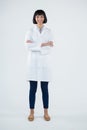 Doctor standing with arms crossed against white background Royalty Free Stock Photo