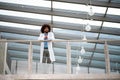 Portrait of doctor standing in hospital, leaning on glass railing, looking at camera. Royalty Free Stock Photo