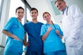 Portrait of doctor and surgeons standing together in corridor Royalty Free Stock Photo