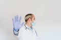 Portrait of doctor wearing protective mask and gloves indoors. Making a stop sign with hand. Corona virus concept Royalty Free Stock Photo