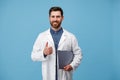 Portrait of Doctor In white uniform with clipboard showing thumbs up Royalty Free Stock Photo