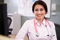 Portrait Of Doctor Working At Nurses Station