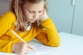 Portrait of dorable teen girl solving sudoku at desk at school or at home. View from above Royalty Free Stock Photo