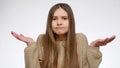 Portrait of doubtful girl showing confusion gesture with hands.