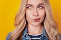 Portrait of doubtful minded smart lady look empty space on yellow background