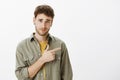 Portrait of doubtful unimpressed attractive european man with beard and curly hair, smirking and raising eyebrows in