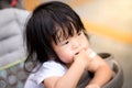 Portrait of doubtfully Asian kids child girl. She wearing a white T-shirt. Royalty Free Stock Photo