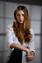 Portrait of dreamy girl in white shirt and jeans with long curly hair Royalty Free Stock Photo