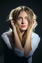 Portrait of dreamy girl in white shirt and jeans with long curly hair Royalty Free Stock Photo