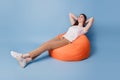 Portrait of dreamy sleepy lady sit beanbag hands head relax enjoy sleep make break on blue background