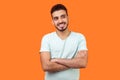 Portrait of dreamy thoughtful bearded man dreaming and thinking of pleasant memories. indoor studio shot isolated on orange Royalty Free Stock Photo