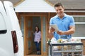 Portrait Of Driver Delivering Online Grocery Order To House Using Digital Tablet Royalty Free Stock Photo
