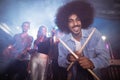 Portrait of drummer holding drum sticks at nightclub