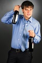 Portrait of a drunk businessman holding two bottles Royalty Free Stock Photo